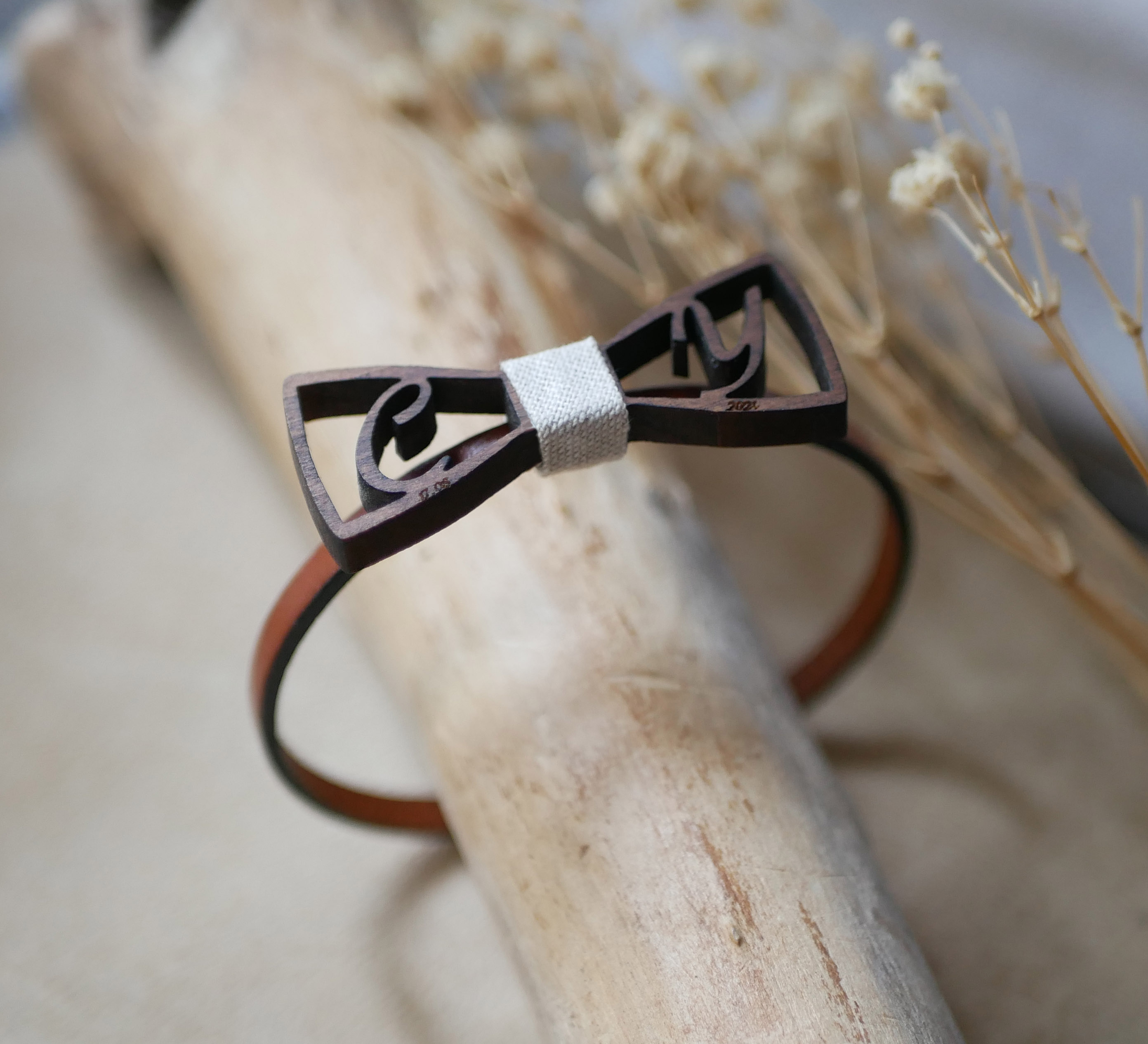 Leren armband met miniatuur houten strikje en opengewerkte initialen